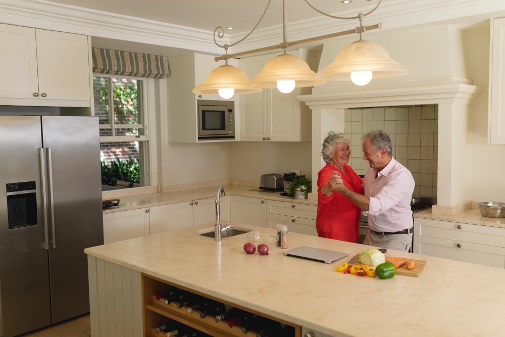 Elderly couple enjoying their newly home renovated, accessible kitchen space