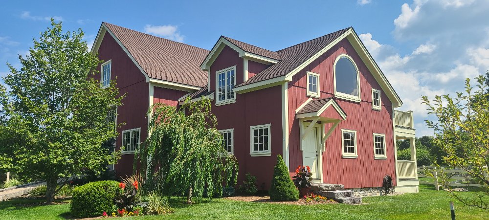 Freshly painted red house with neat landscaping and vibrant colors